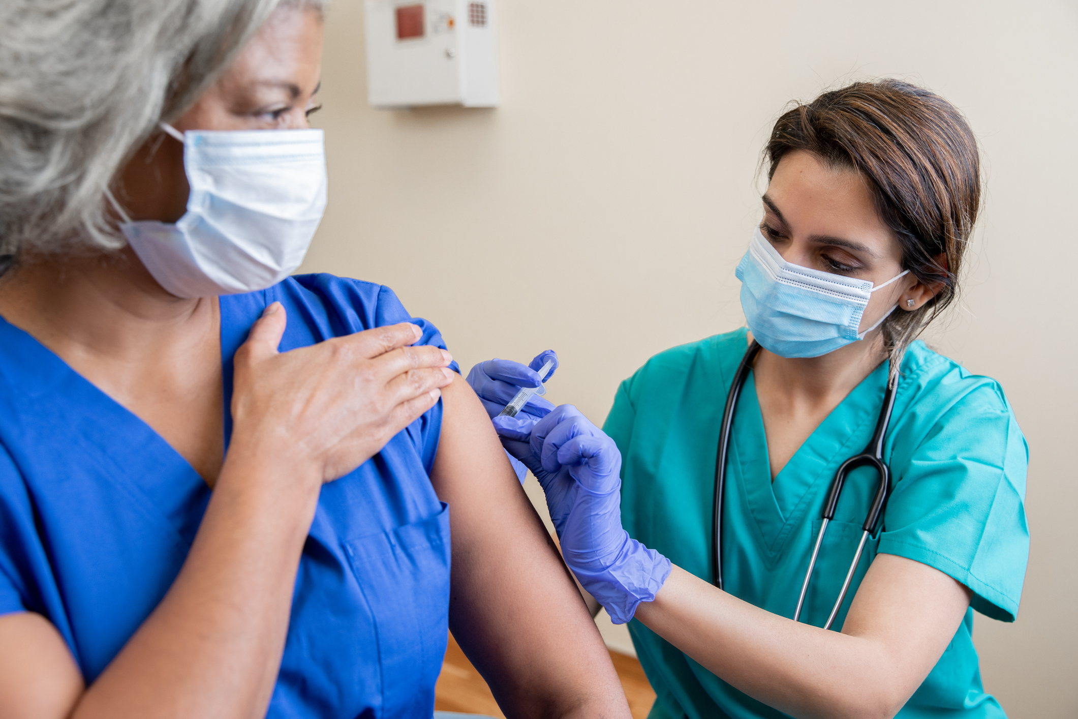 Nurse vaccinating patient.