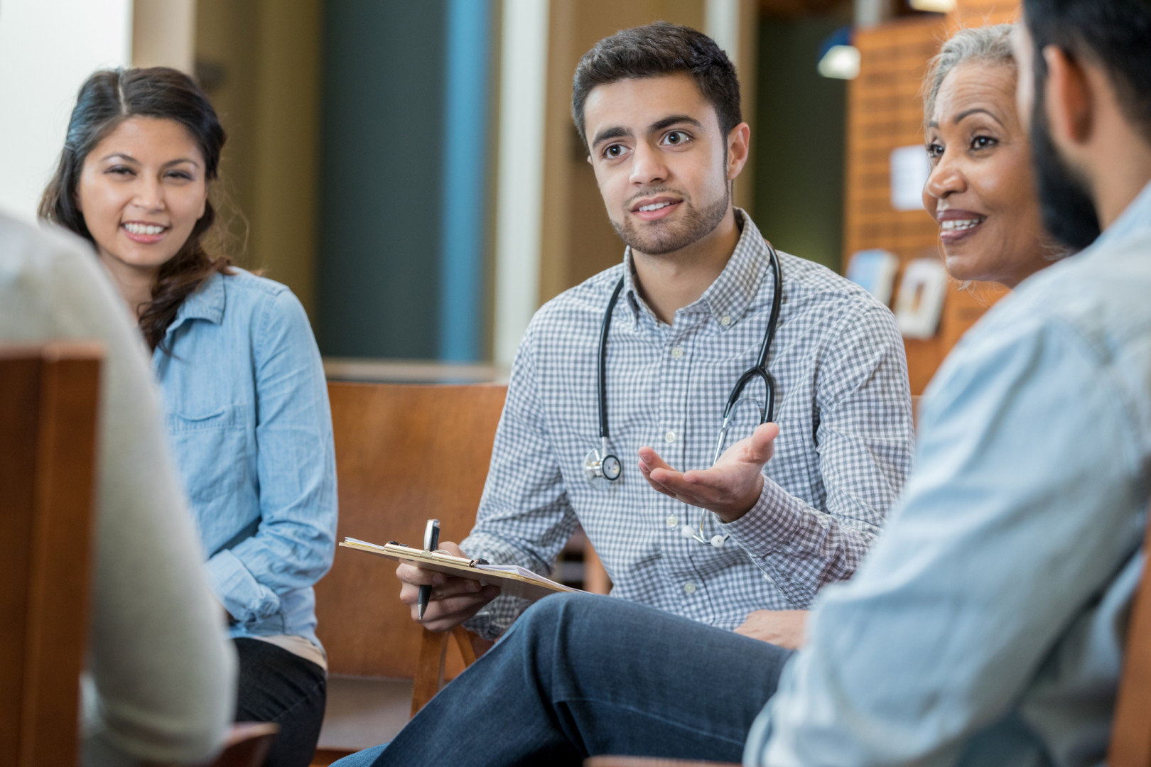 Elderly woman sitting with health professional.