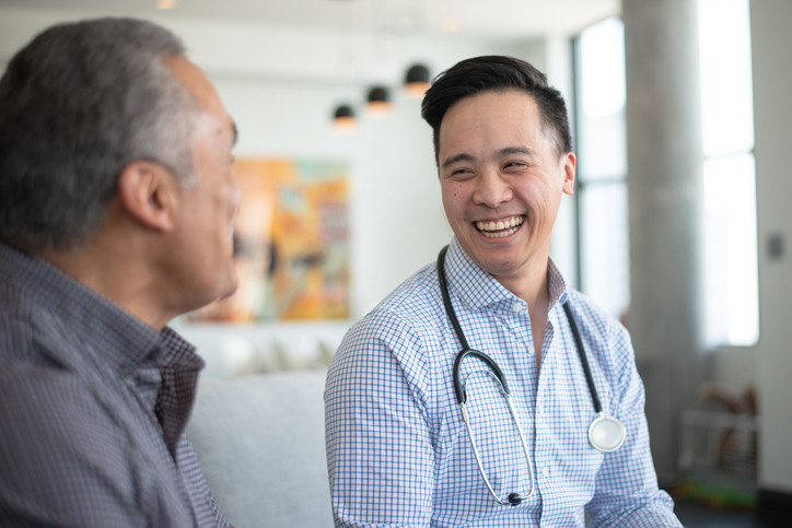 Make doctor, smiling and talking with patient.