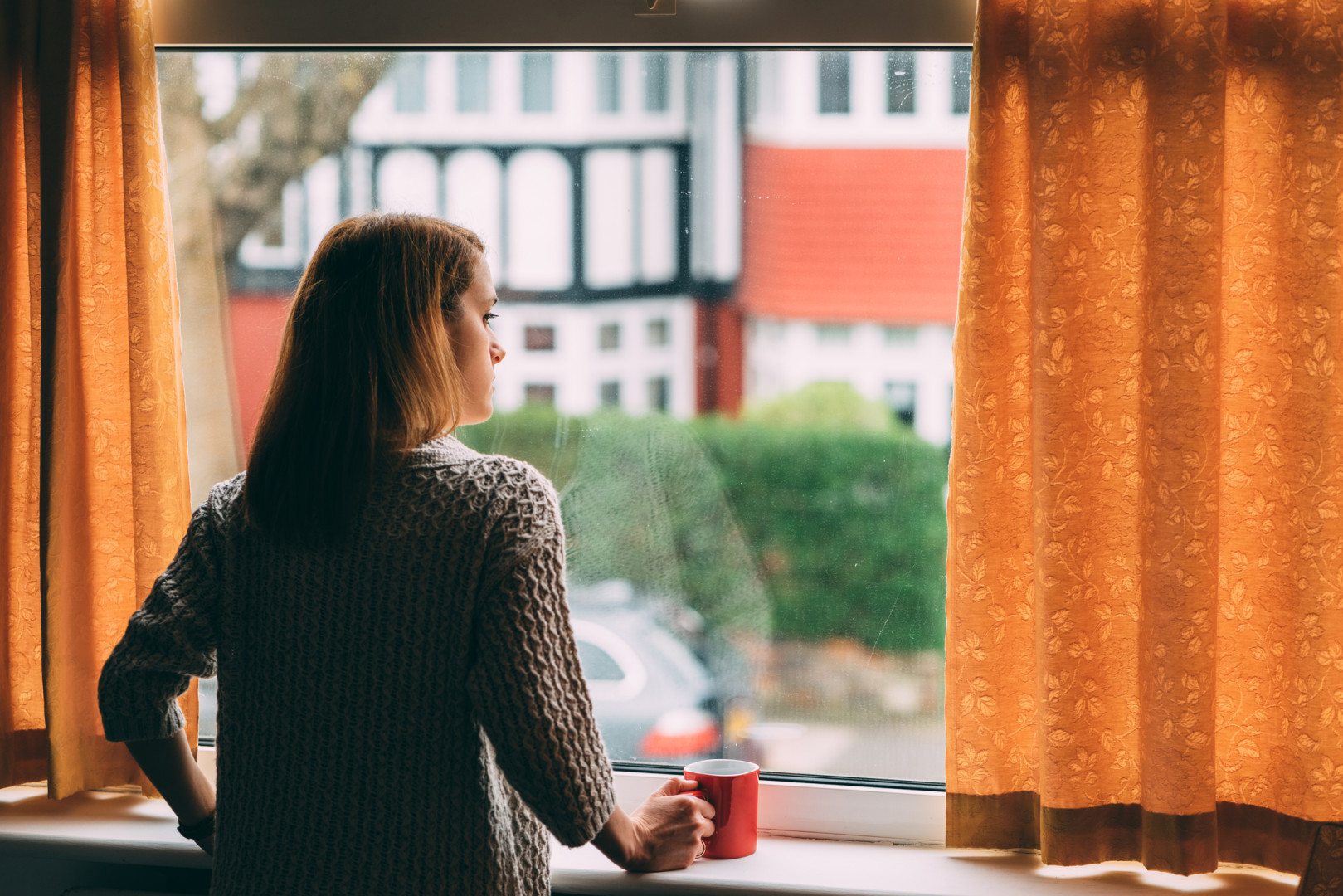 woman looking out the window