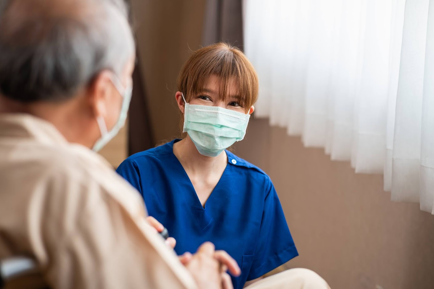 Nurse with elderly male patient.