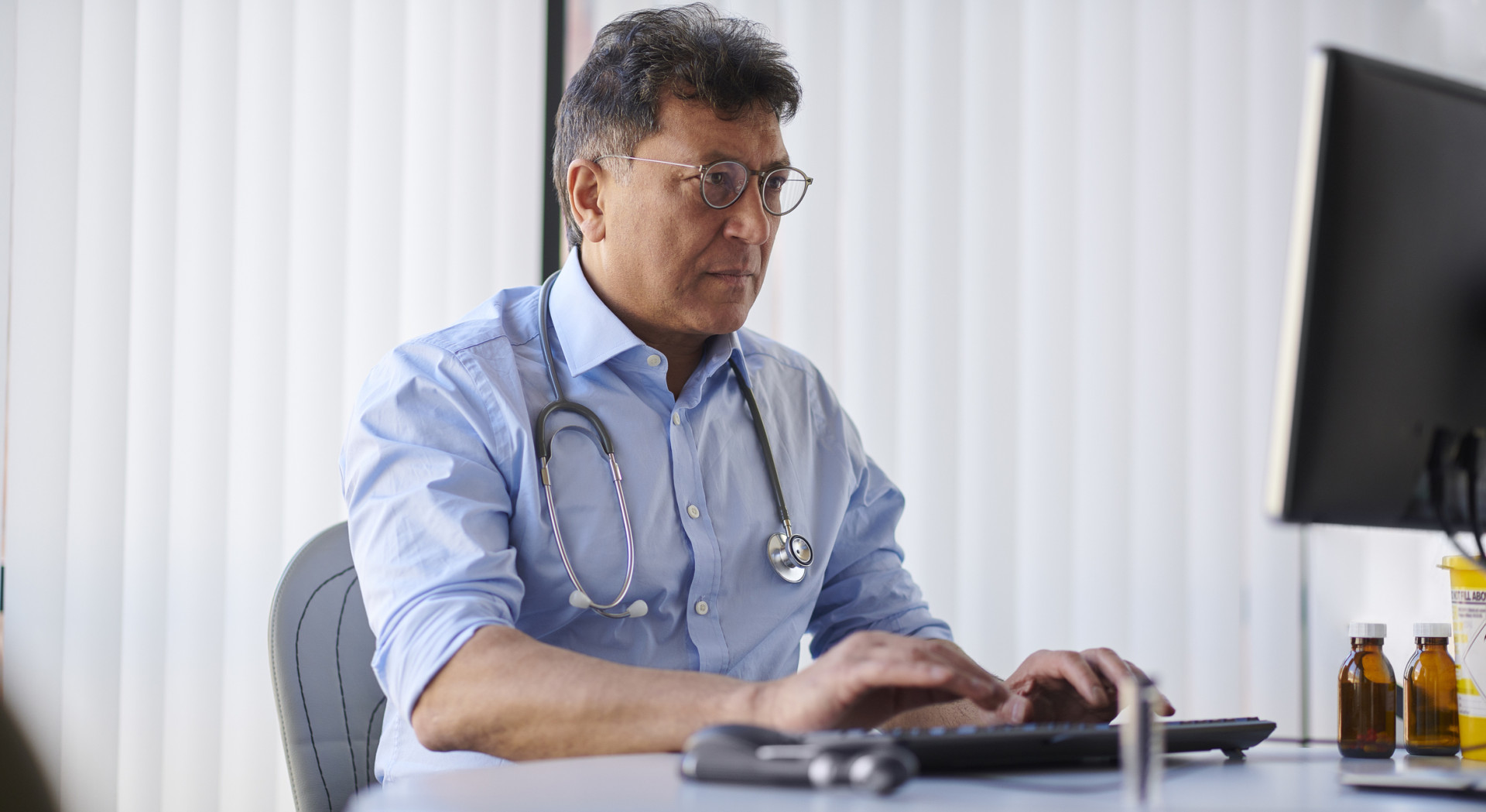 Doctor searching information on computer.