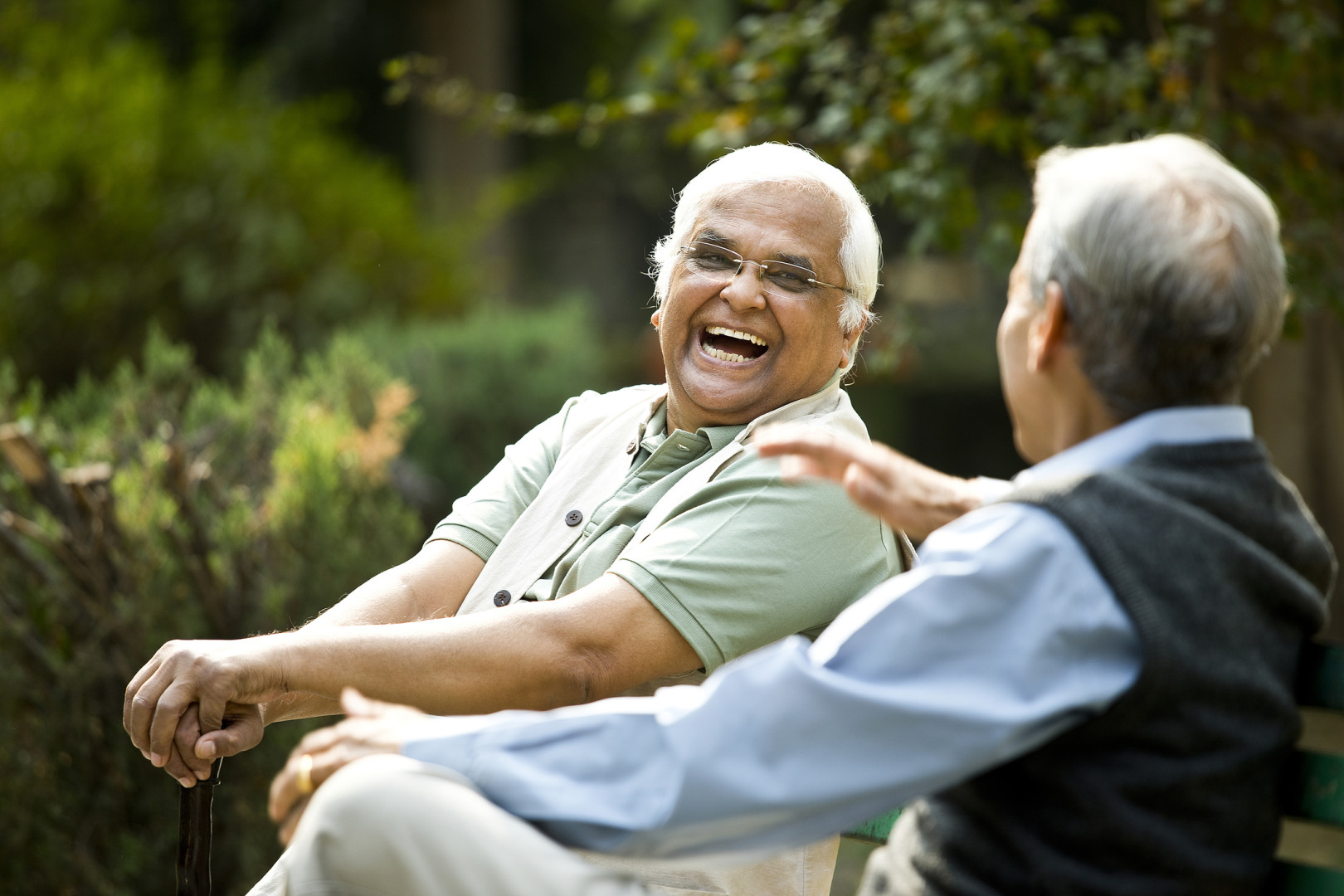 Two men, laughing together.