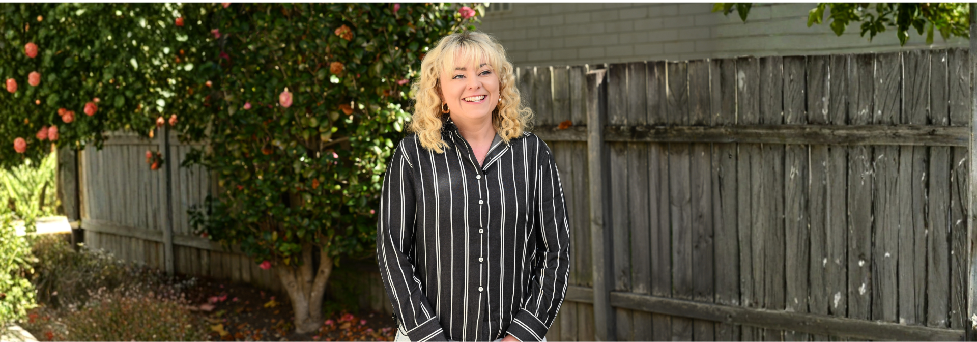 Courtney Cross pictured in front of a garden fence