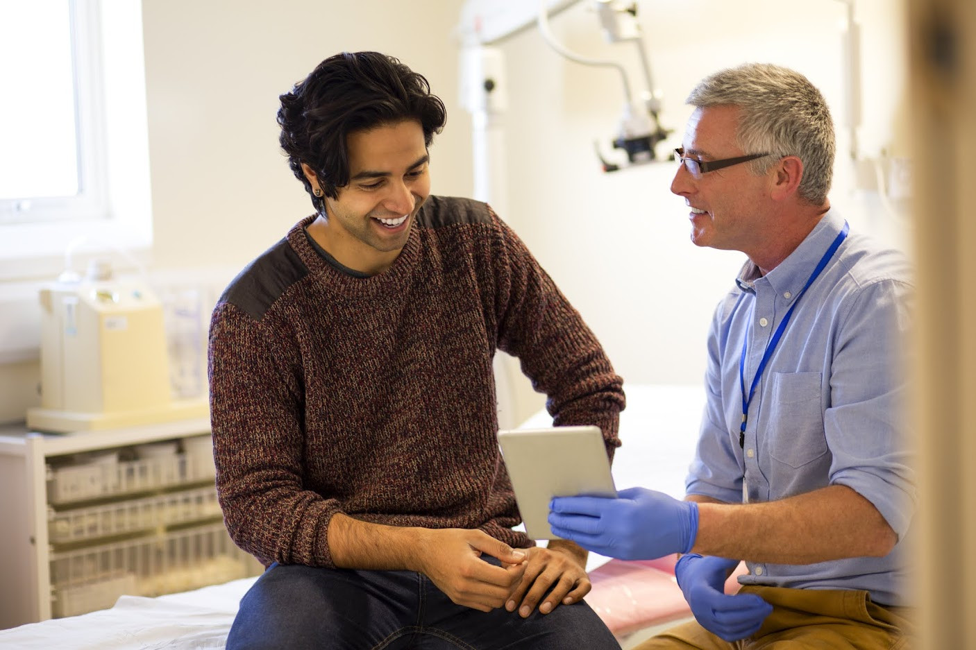 Male doctor and patient talking and smiling.