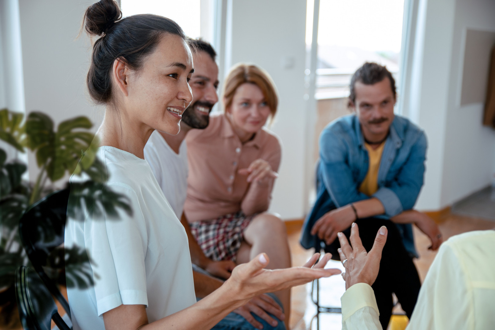 Peer worker speaking with other peer workers in a circle