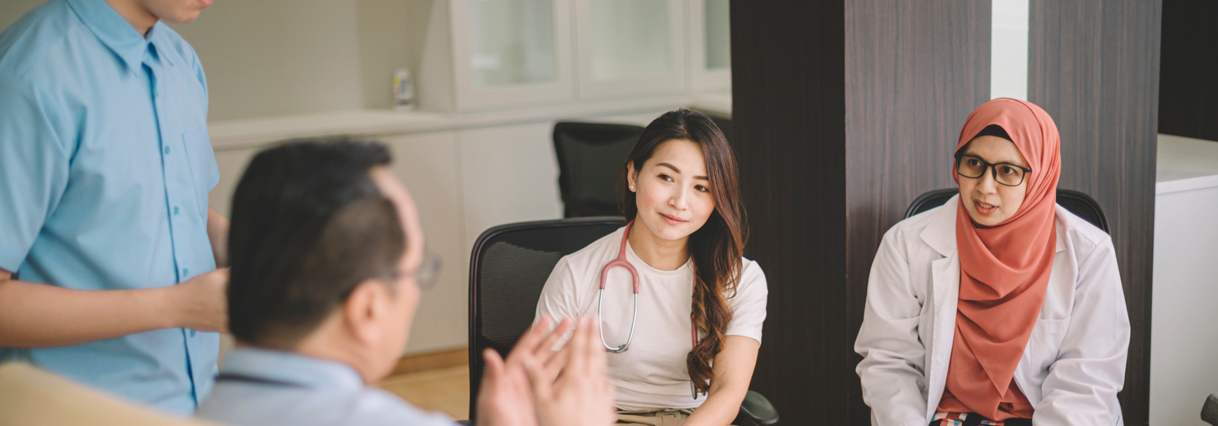 Health professionals talking in a circle