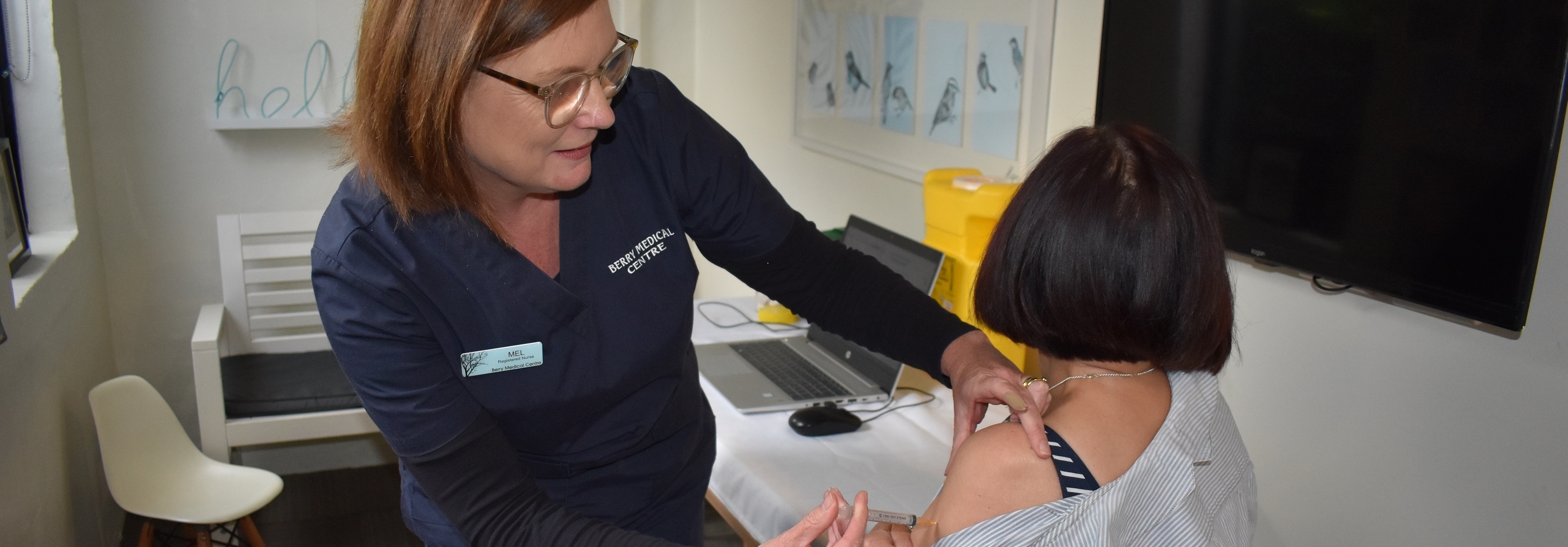 Local nurse administering COVID vaccine to patient.
