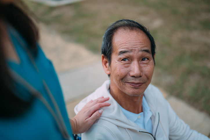 Man outside with health care nurse.