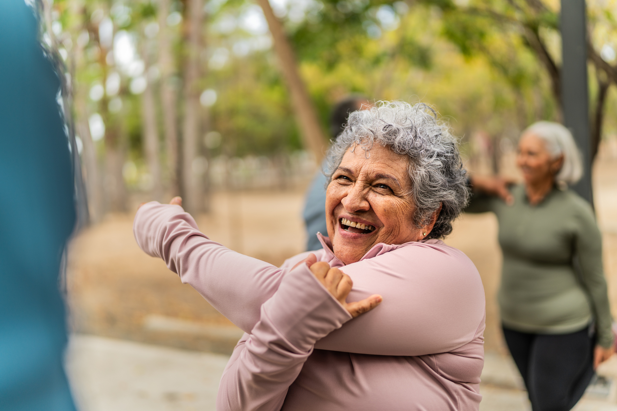 Older person stretching outside before going for a run.