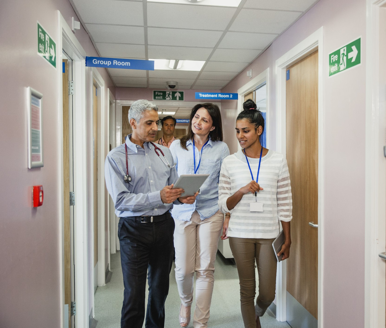 GP and allied health professionals walking down a corridor together