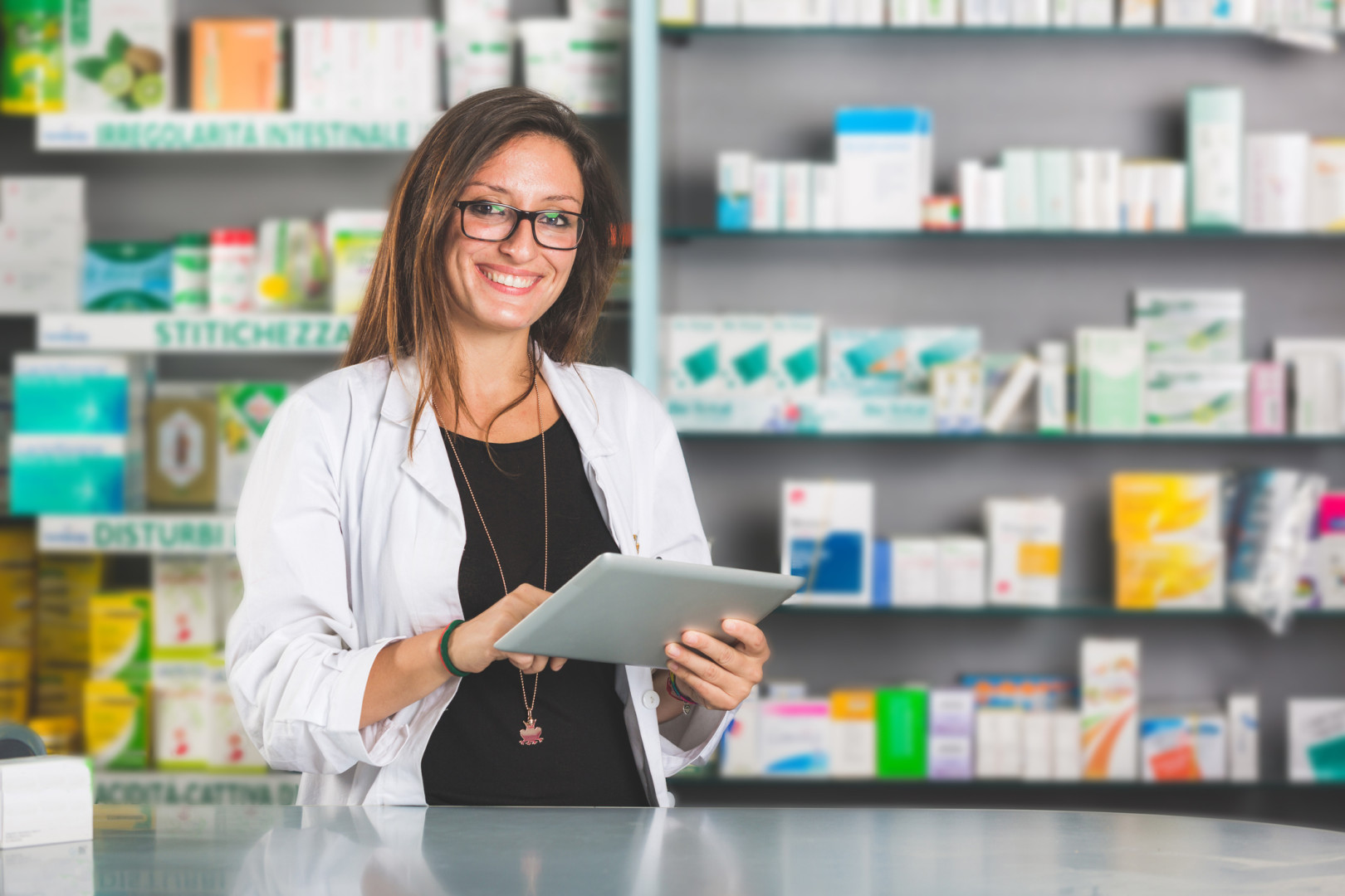 Female pharmacist, smiling and holding file.