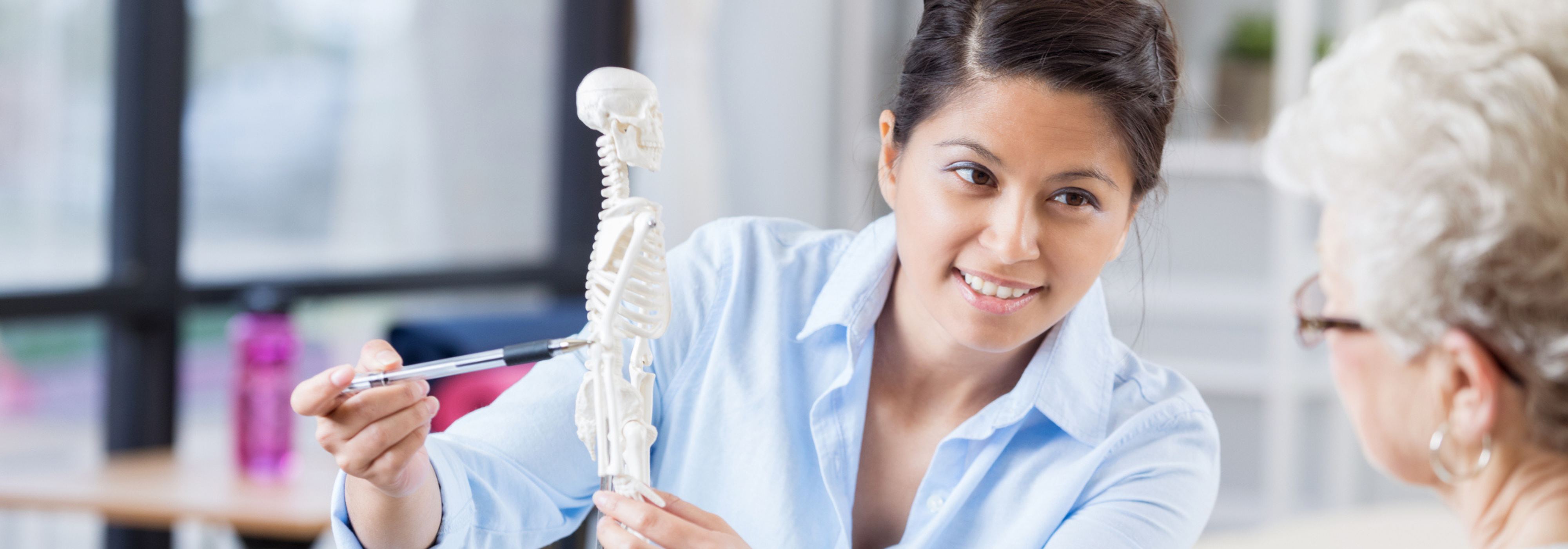 Nurse showing an elderly patient their bone screening results.