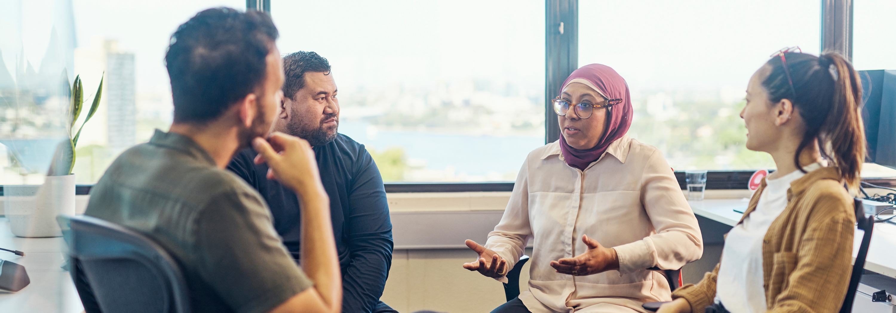 People talking in a circle at an office