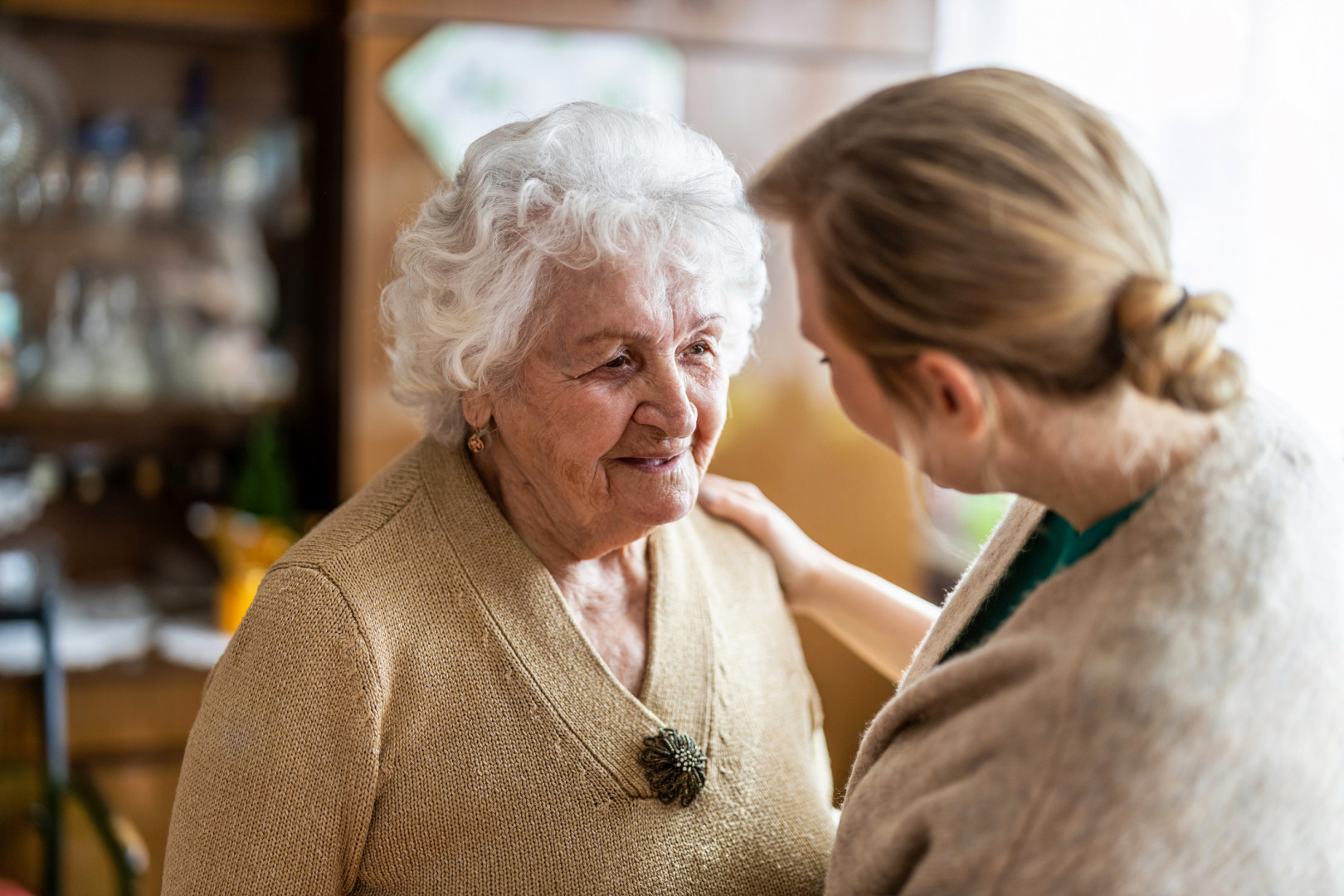 Elderly lady talking to her daughter.